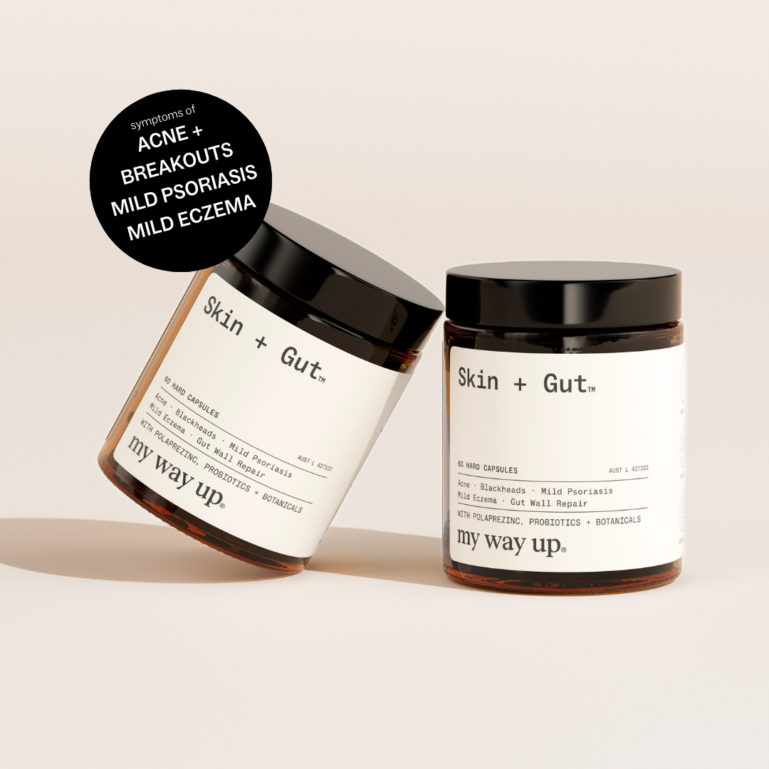 Two jars of 'Skin + Gut' capsules by 'my way up' on a beige background.