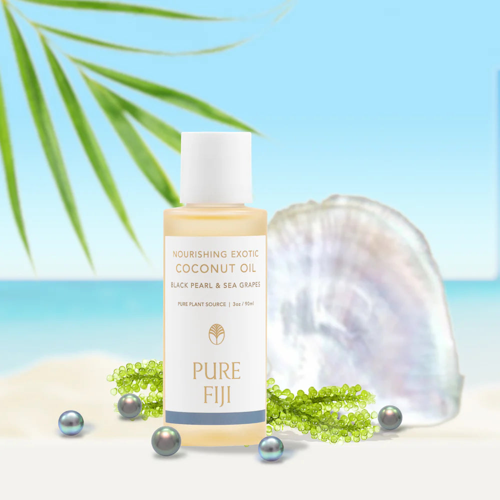 Coconut oil bottle with shell and pearls on a beach background